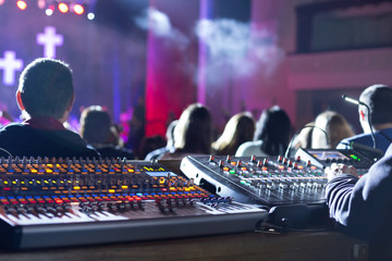 Soundman working on the mixing console.