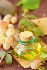 Bottle with grape seed oil on a wooden table