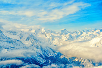 Fototapeta na wymiar majestic view of winter day landscape Dombaj mountains with blue