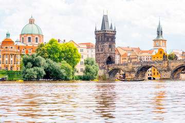 Fototapeta na wymiar Citycsape view on the riverside with the bridge and old town in Prague