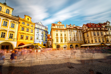 View on the old town square with colorful buildings in Prague city. Long exposure image technic with blurred people and clouds