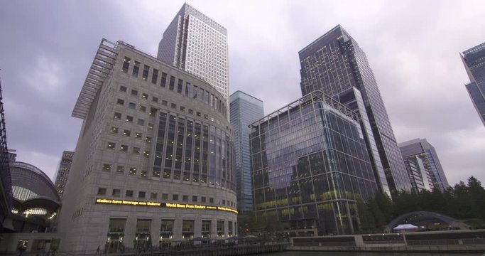 Time lapse view of the financial district of the Docklands in London with news ticker tape scrolling