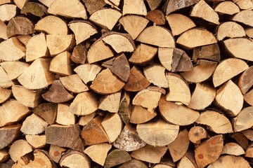 wall firewood , Background of dry chopped firewood logs in a pile. Stack of logs felled and left to dry.
