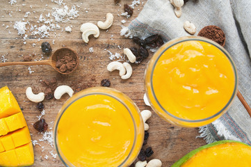 Two glasses of mango mousse. Top view. Blurred background