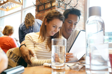 Couple in restaurant choosing menu