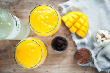 Two glasses of mango mousse. Top view. Blurred background
