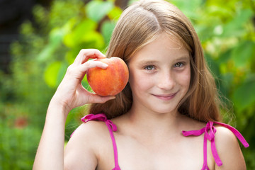 Portrait of a young blonde little girl with peach