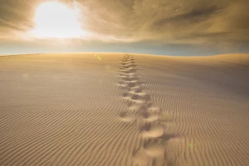 Foto auf Acrylglas Steps of human foot mark on windy white sand dunes, Muine desert, Phan Thiet, Vietnam © akeeris