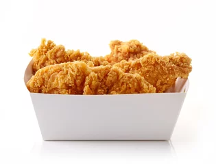 Foto auf Acrylglas Fried breaded chicken fillet in white cardbord box © bigacis