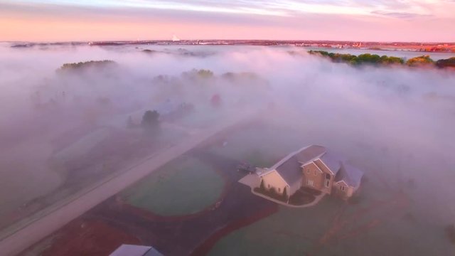 Twilight landscape with homes and foggy autumn river, Fall colors adorning shore.
, aerial view.