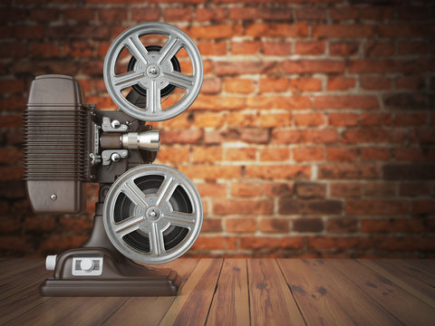 Vintage projector on the bricks background. Cinema, movie or vid