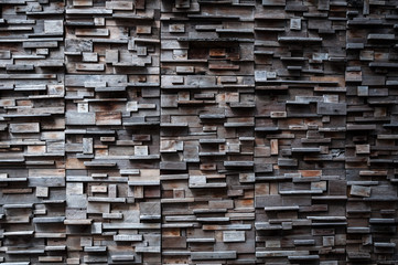 exposed wooden wall exterior, patchwork of raw wood forming a beautiful parquet wood pattern,Wood wall pattern,for background