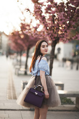 Fototapeta na wymiar Young Asians girl with modern dress posing in an old Krakow
