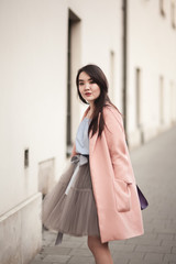 Young Asians girl with modern dress posing in an old Krakow