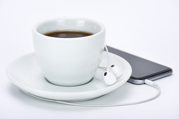 Cup of tea with mobile phone and headphone