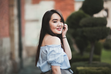 Young Asians girl with modern dress posing in an old Krakow