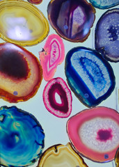 Colorful slices gemstones agates and opal jewellery  illuminated background
