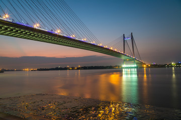 Fototapeta na wymiar Vidyasagar bridge (setu) on river Ganges at sunset. Also known as the second Hooghly bridge it is the longest cable stayed bridge in India.