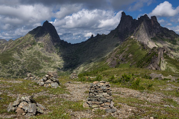 Stone pyramid on a background of mountain peaks. Natural Park Ergaki. Western Sayan. Russia.