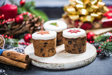 Fototapeta na wymiar Traditional Christmas fruit rich cakes with decoration