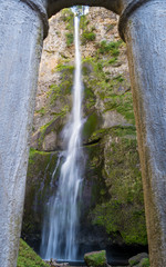 Upper part of Multnomah Falls framed in pillars of Creek Bridge