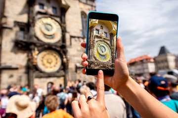 Naklejka premium Photographing with smart phone a famous astronomical clock on the town hall in Prague city