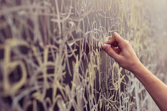 Hand Writing With Chalk On Full Filled Board. Close Up