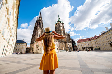 Naklejka premium Young female tourist in front of the Vitus cathedral in the old town of Prague. Enjoying great vacation in Czech republic