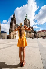 Papier Peint photo Lavable Prague Young female tourist in front of the Vitus cathedral in the old town of Prague. Enjoying great vacation in Czech republic