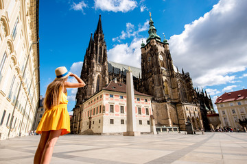 Naklejka premium Młoda turystka kobieta przed katedrą Wita na starym mieście w Pradze. Wspaniałe wakacje w Czechach