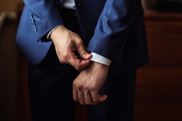 Businessman wears a jacket.Politician, man's style,male hands closeup, American, European businessman, business, fashion and clothing concept - Powered by Adobe