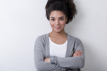 A young confident woman in casual clothes on white background