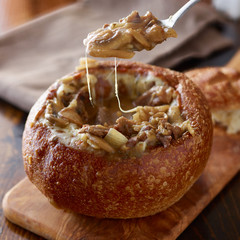 eating philly cheese steak sourdough breadbowl