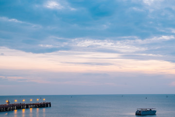Obraz premium Beautiful illuminated shining in twilight at Prachuap port