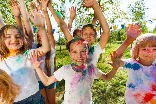 Portrait of bright kids smeared in colored powder