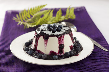 Sweet pudding with blueberry confiture