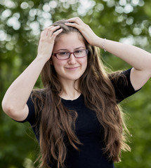 Young Woman with Long Hair wearing Glasses and Smiling
