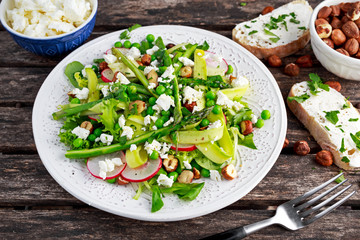 Fresh Green Asparagus salad witch Goat Cheese, peas, radishe, zucchini, lettuce and Hazelnuts.