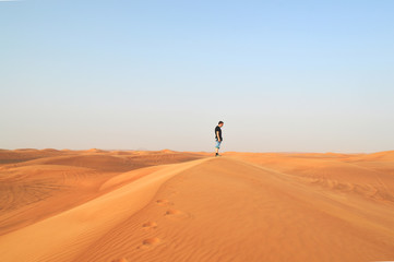 Fototapeta na wymiar man in the setting sun in the desert