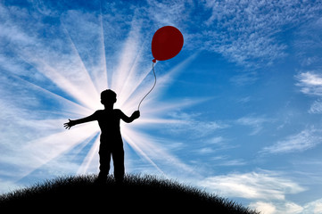 Silhouette of boy on hill with balloon day