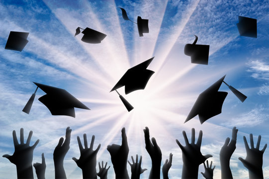 Hands throwing graduate cap in sky