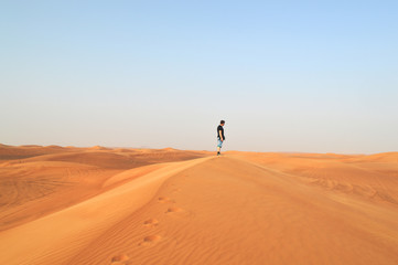 man in the setting sun in the desert