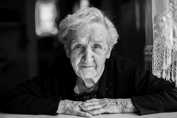 Black and white contrast portrait of an elderly woman.
