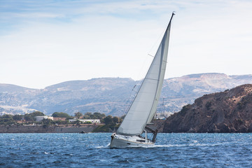 Sailing ship luxury yacht with white sails in the Sea.