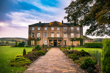 Fototapeta na wymiar Walton Hall in a scenic setting of rolling parkland with its own
