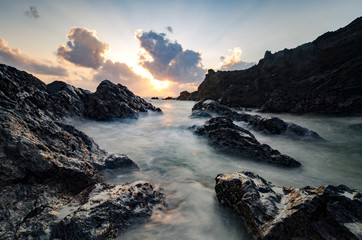 beautiful scenery and magical light of Pandak beach Located in Terengganu,Malaysia during sunrise with shadow of rocks .soft focus and motion blur