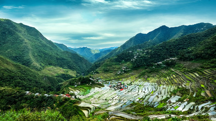 Amazing panorama view of rice terraces fields in Ifugao province mountains under cloudy blue sky....