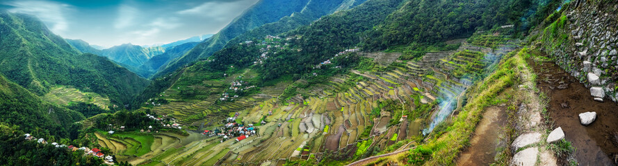Amazing panorama view of rice terraces fields in Ifugao province mountains under cloudy blue sky....