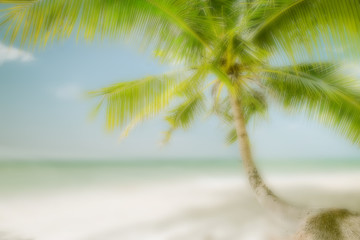 Abstract blurred background for travel concept. Sunny day at amazing tropical beach with palm tree, white sand and turquoise ocean waves. Myanmar (Burma) landscapes and destinations