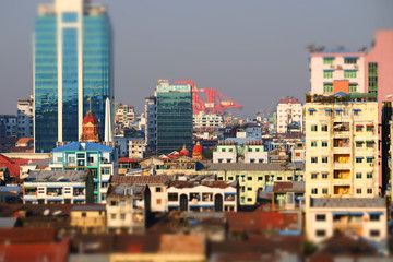 Plakat Tilt shift blur effect. Futuristic aerial view panorama of developing Yangon city. Myanmar (Burma)